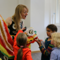 Staff member showing children Chinese dragon