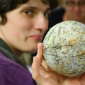Woman holds a celestial globe