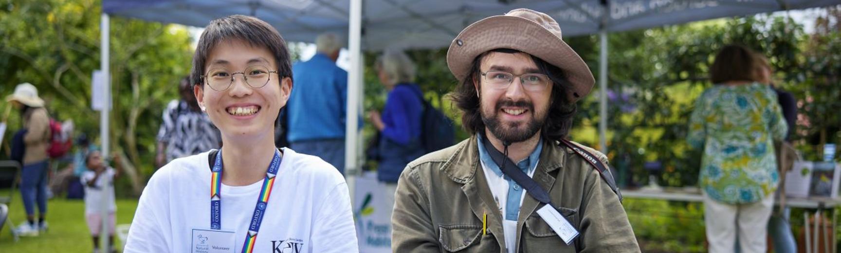 Two volunteers sat behind an activity station at the Botanic Garden 