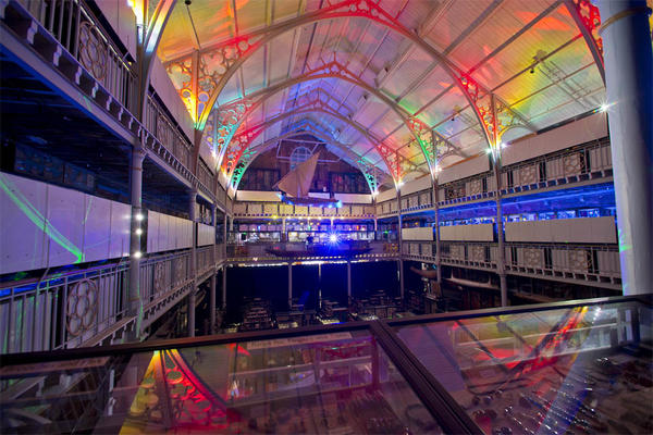Overlooking museum main court showing colourfully lit ceiling and display cabinets